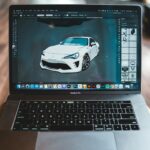Picture of sports car in graphic editor application on screen of modern laptop