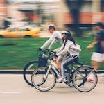 Woman and Man Riding on Bike
